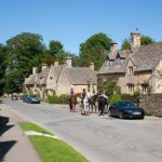 Horse riders strolling through a village