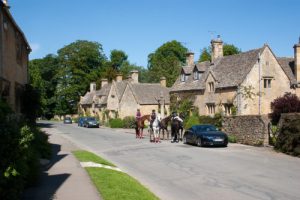 Horse riders strolling through a village