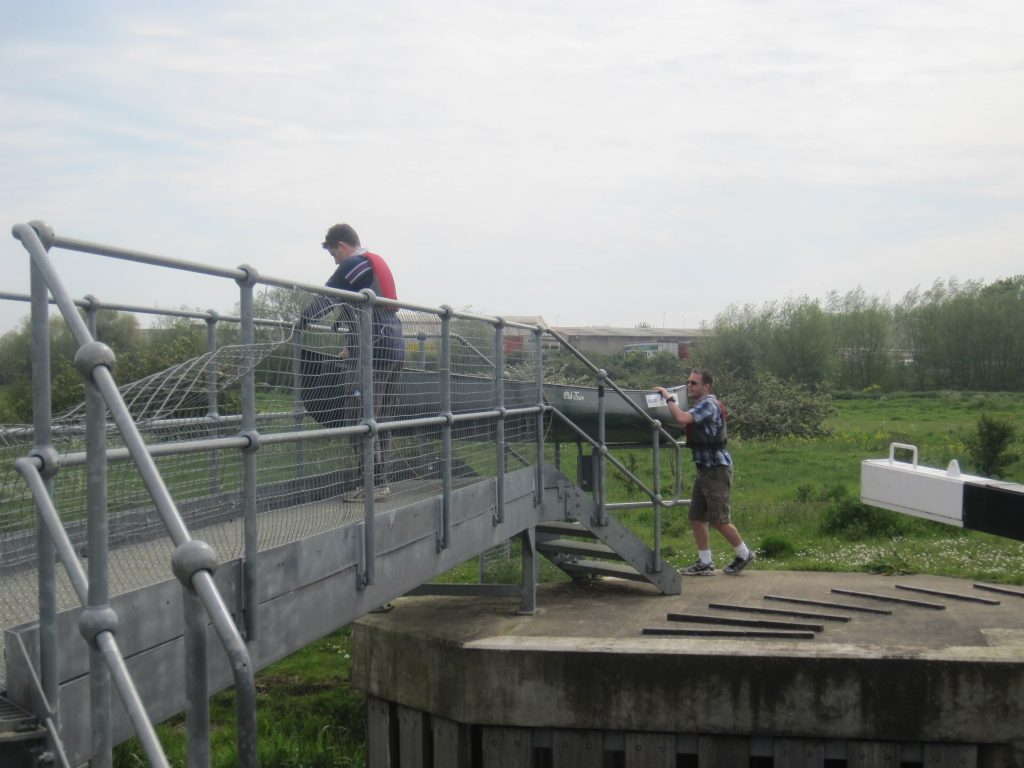 Al and Matt carrying their canoe over the bridge