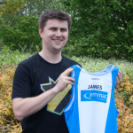 James S holding the team running vest