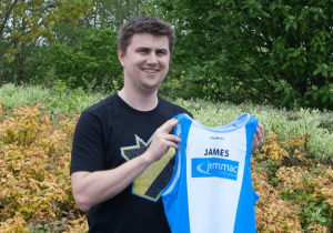 James S holding the team running vest