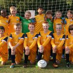 Team photo infront of a goal post