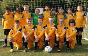 Team photo infront of a goal post